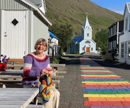 Aud Lise strikker Pride skjerf i Seydisfjordur.jpg